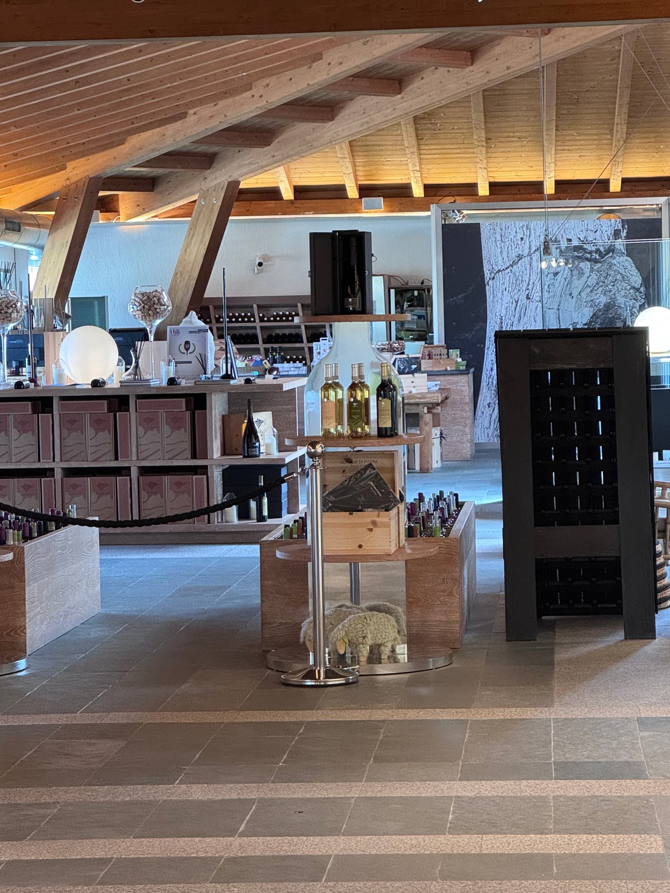 Surrau tasting room with timber beams, bottles and artwork